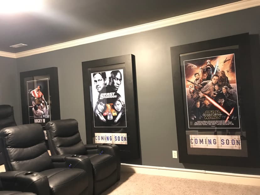 Home theater featuring iconic movie posters and comfortable seating, ideal for film enthusiasts.